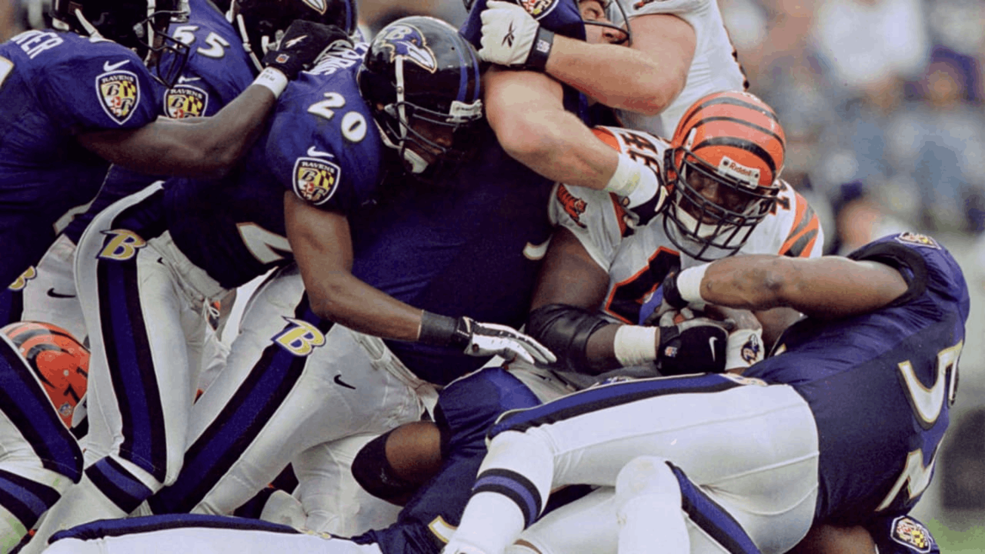 2000 baltimore ravens defenders tackling a cincinnati bengals player during an nfl game