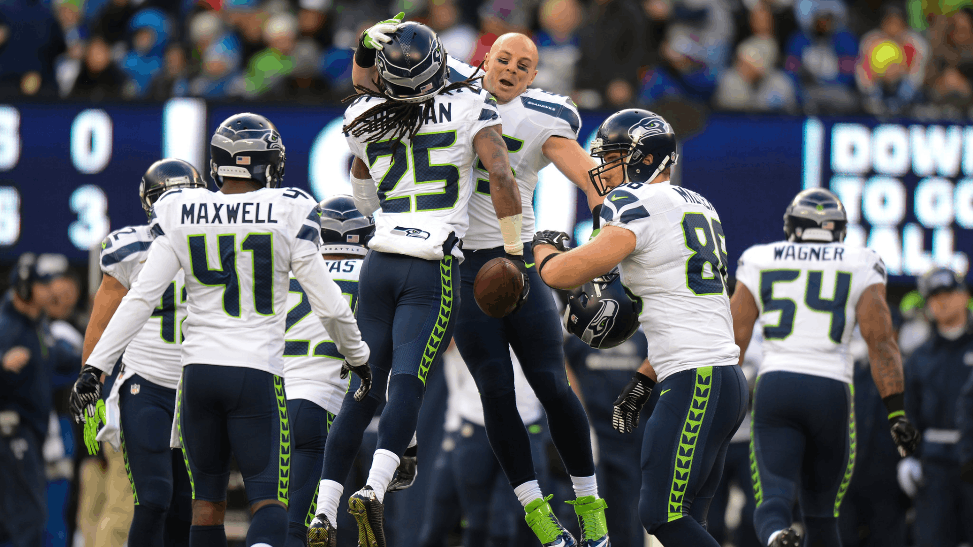 2013 seattle seahawks defenders celebrating together on the field during their dominant super bowl championship season