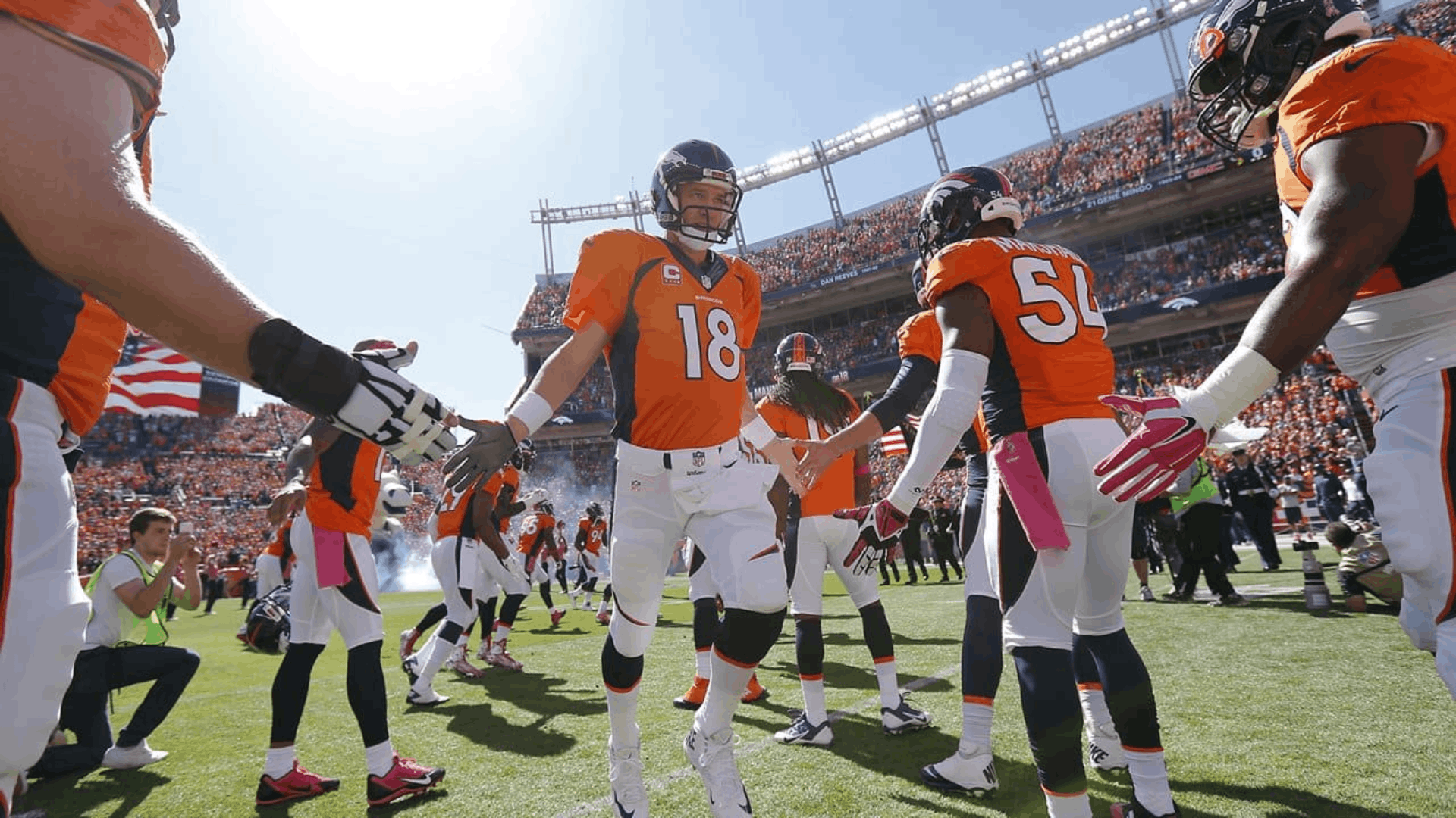 2015 denver broncos players gathering on the field during their super bowl championship season