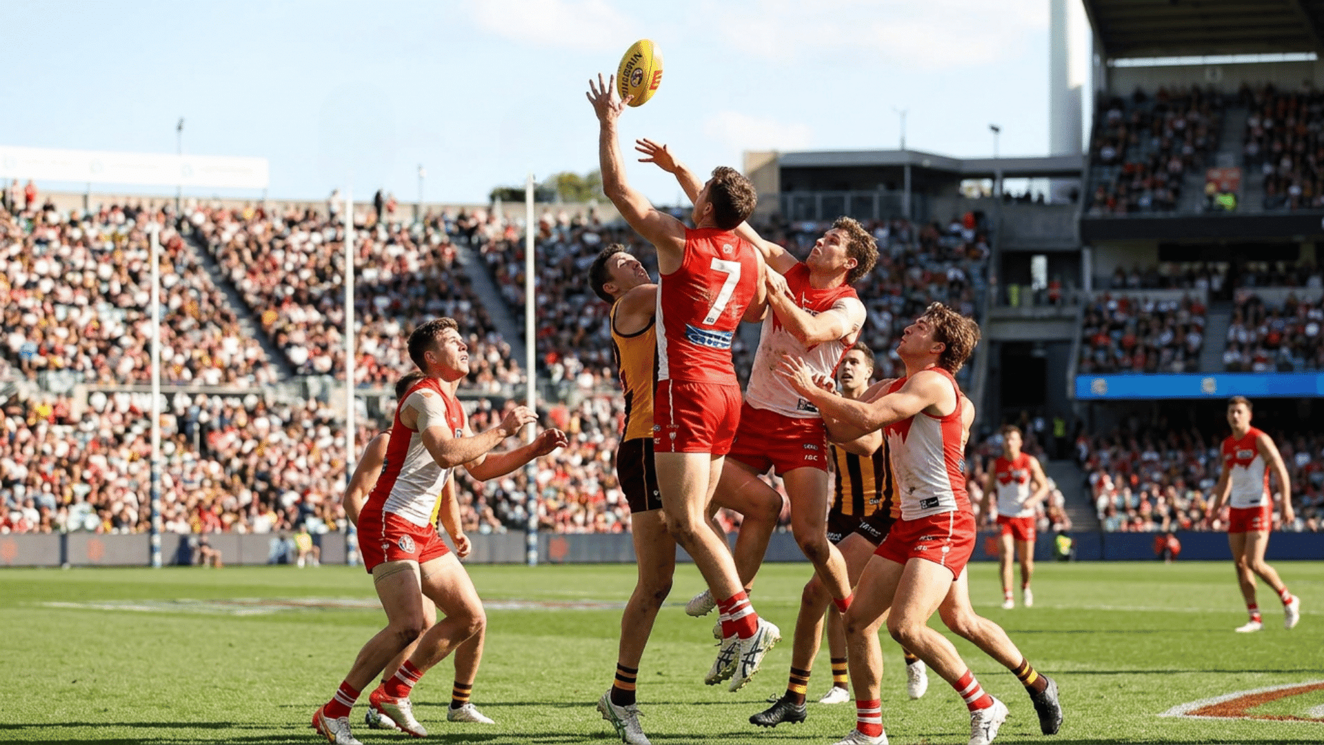 Australian Rules Football players leap to contest a high mark during a packed stadium match on a sunny afternoon