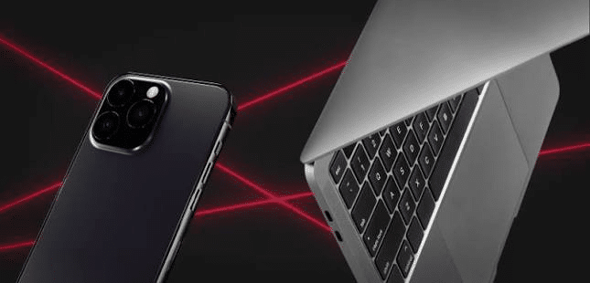 Smartphone and laptop with open screen against dark background with red laser lines