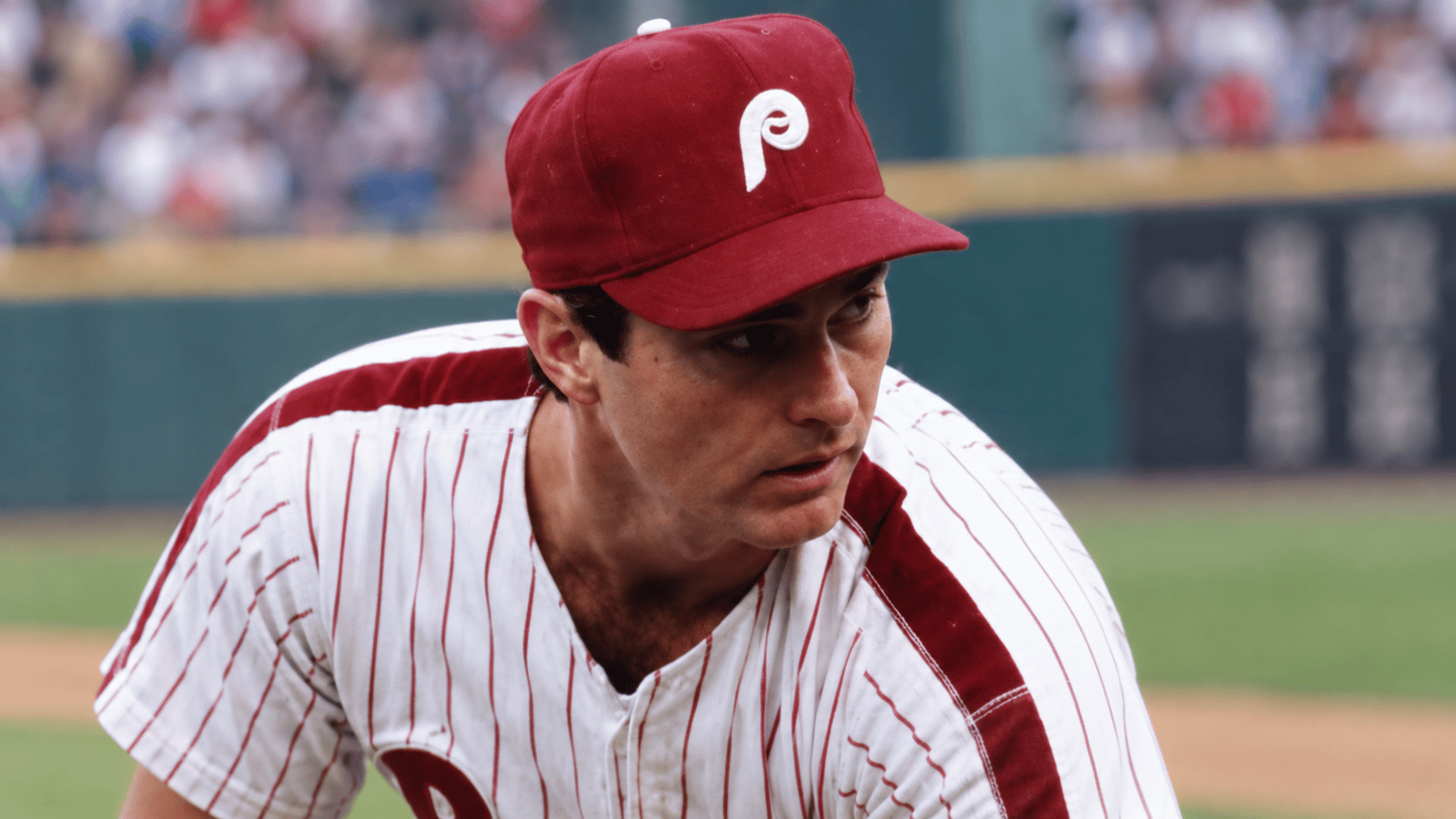 philadelphia baseball pitcher wearing a red team cap and pinstriped uniform during a baseball game