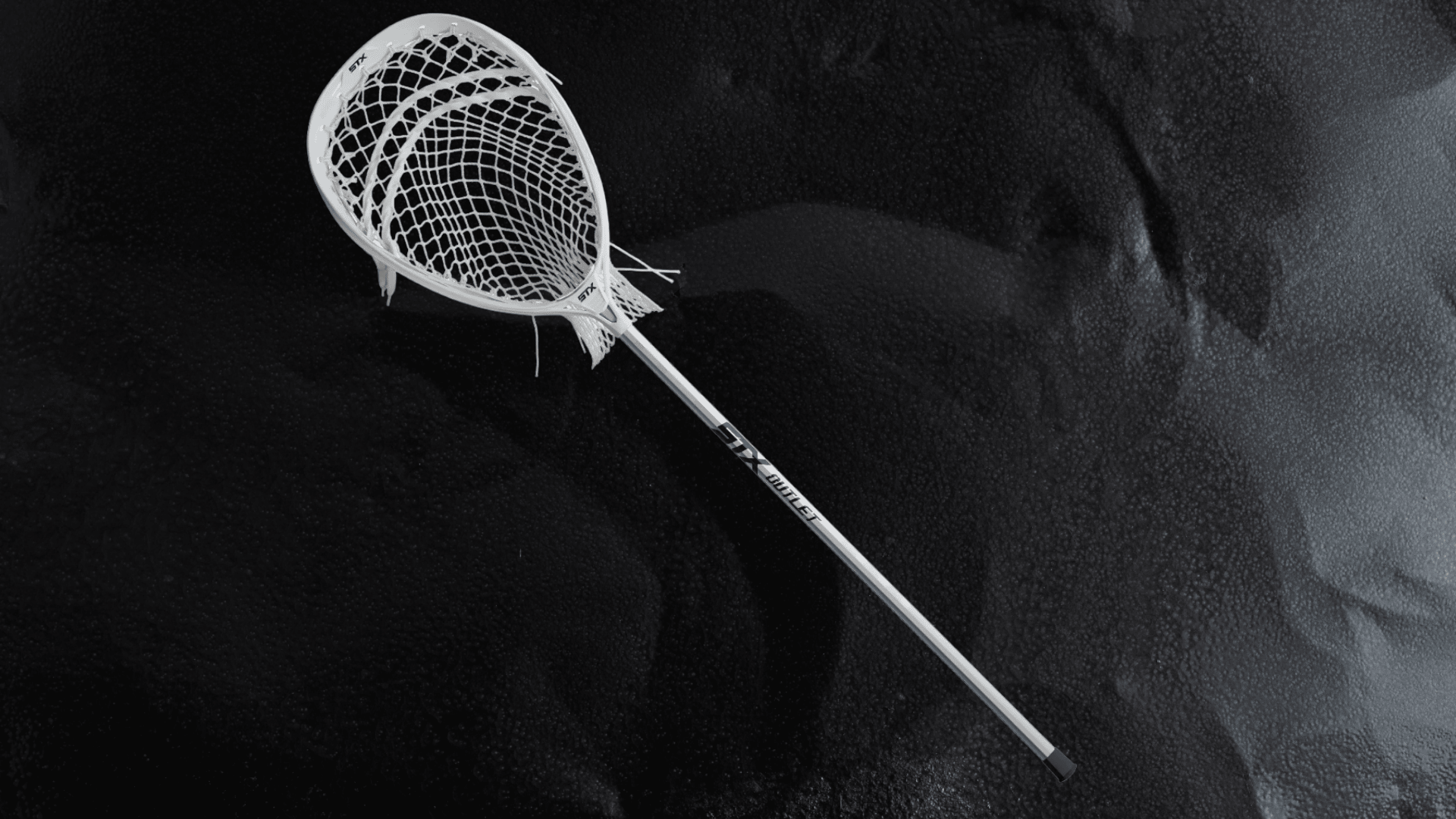 stx eclipse iii complete goalie lacrosse stick with white head and silver shaft on a dark background