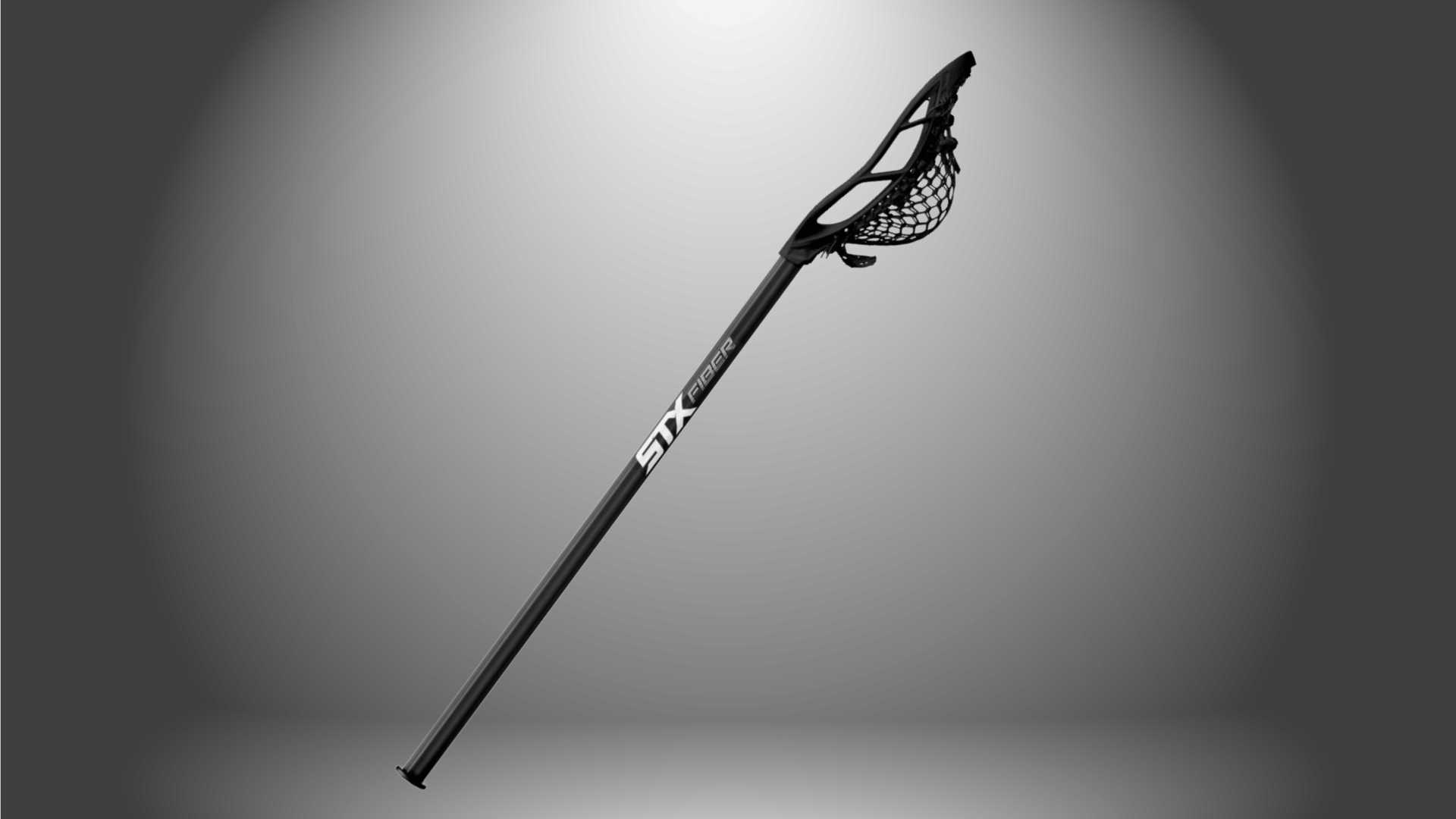 stx stallion 1k complete lacrosse stick with black shaft and white head on a gray background