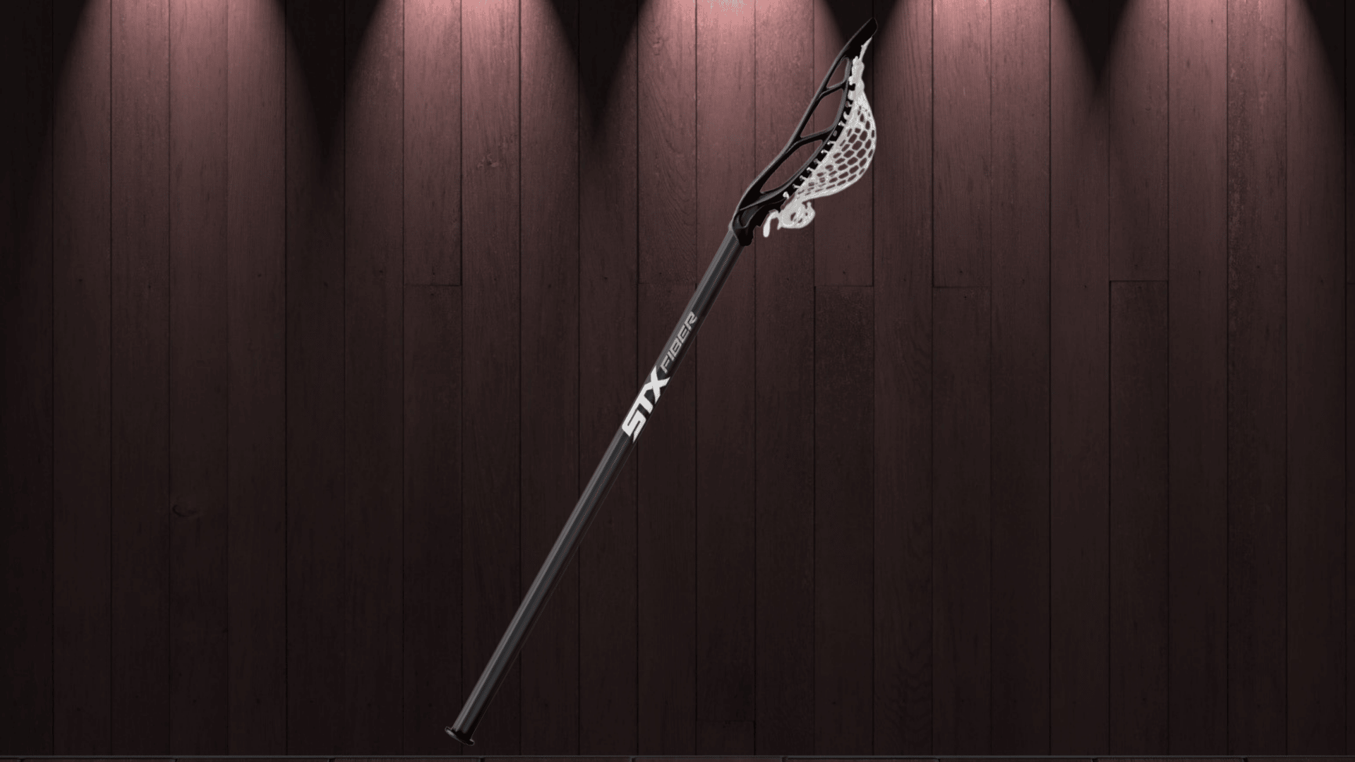 stx stallion 700 complete lacrosse stick with dark shaft displayed against a brown studio background