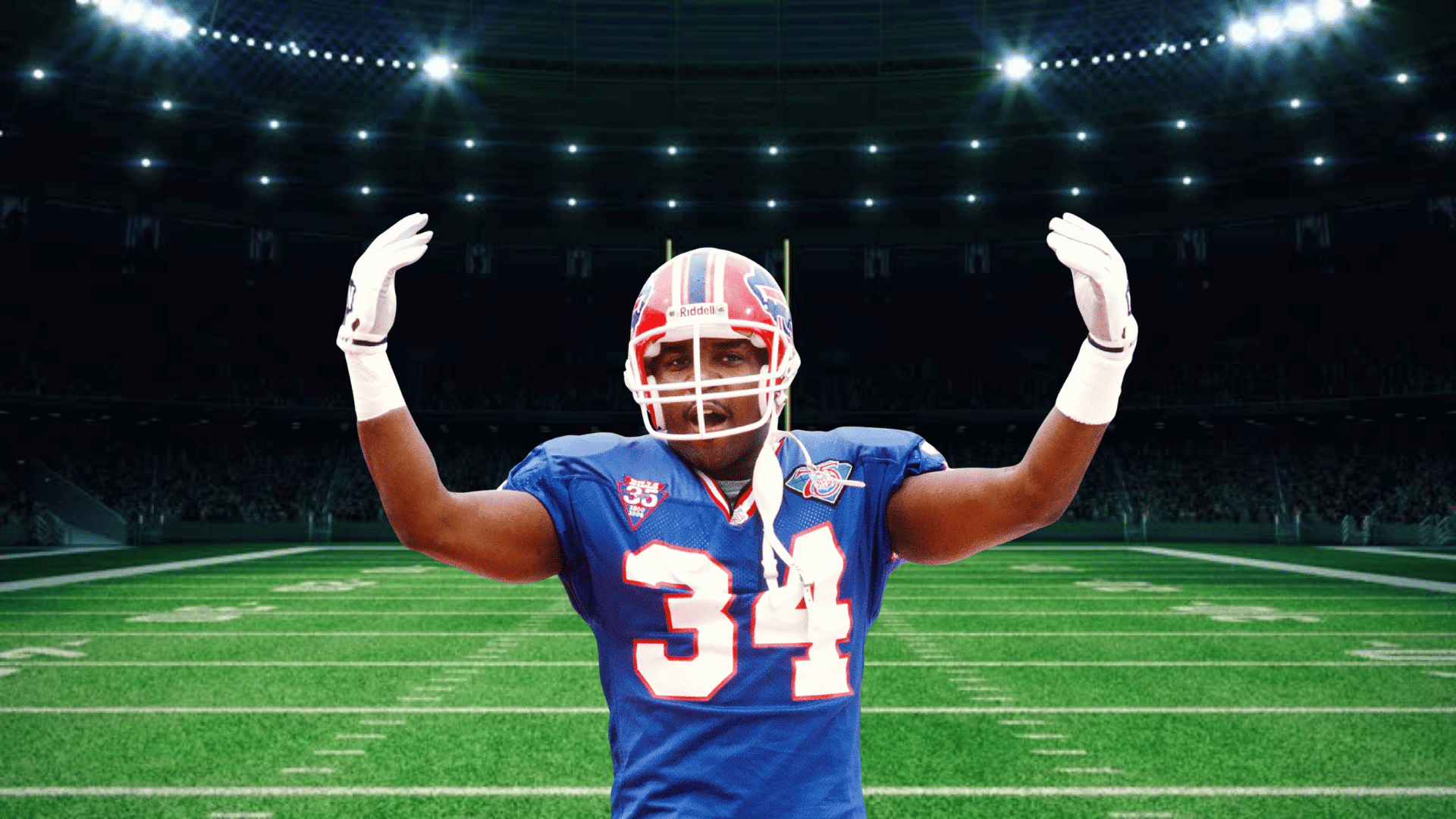 football player wearing a blue number 34 uniform raising both arms on a brightly lit stadium field